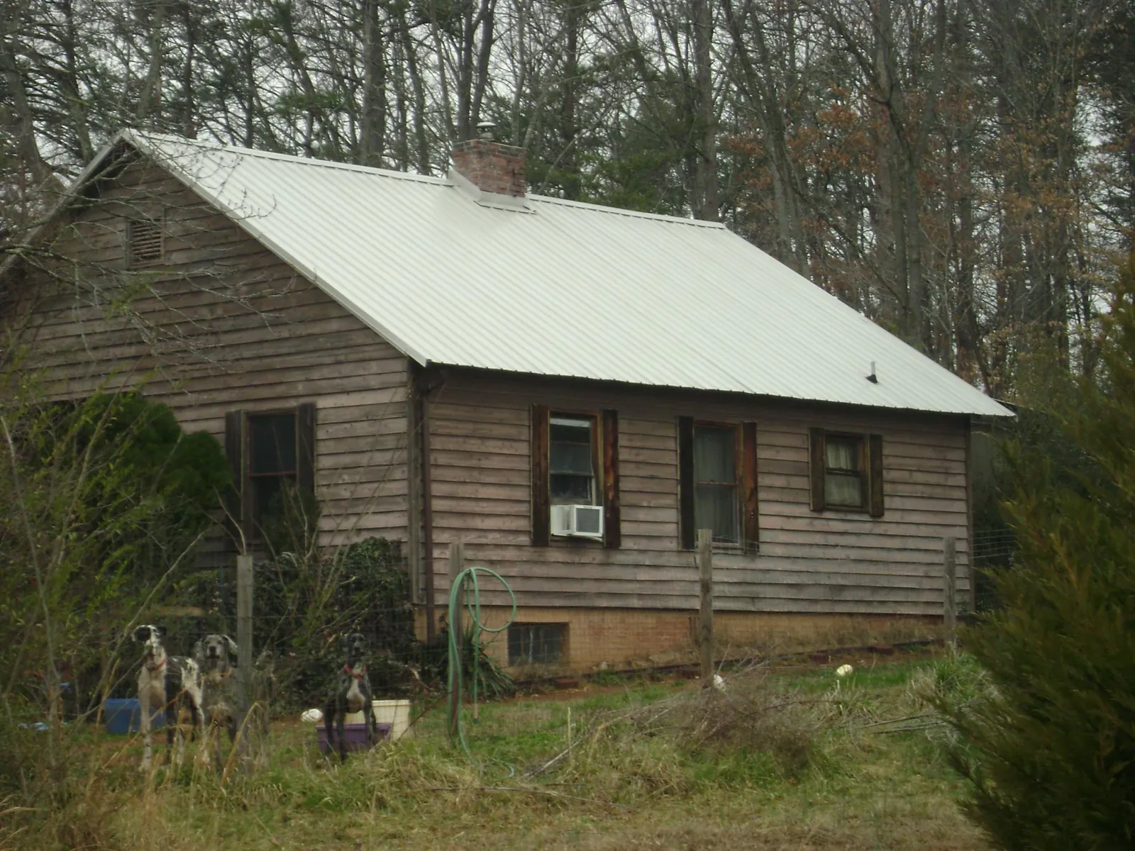 White metal roof on an old wood sided farmhouse, from a Asphalt Shingle Roof Repair job in Lampasas